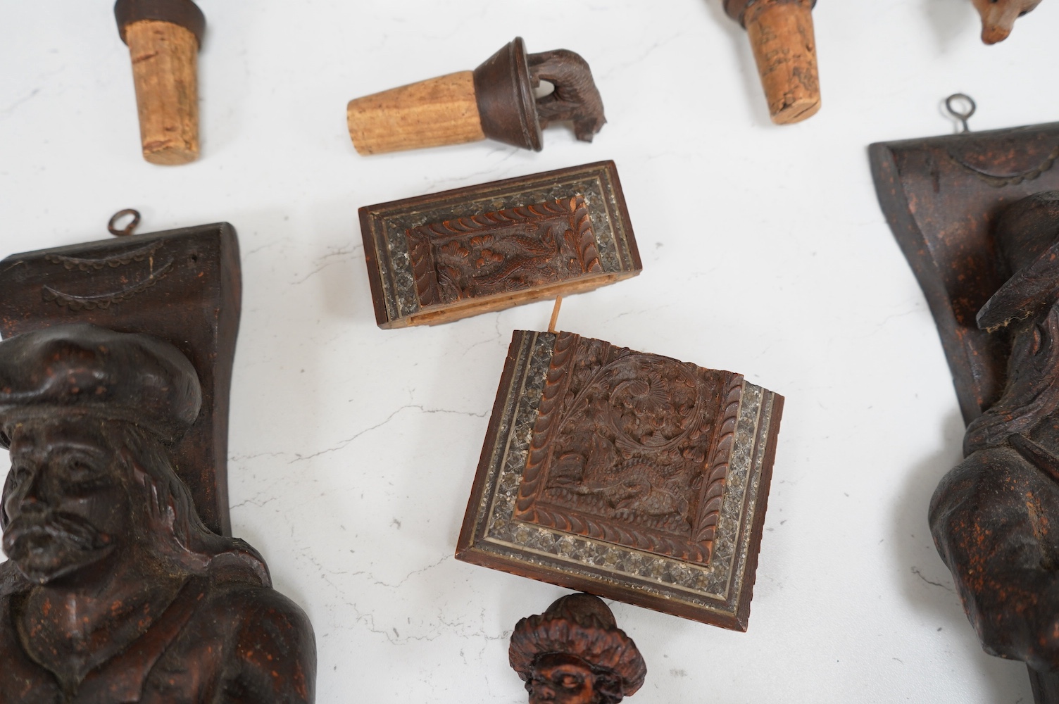 A collection of Black Forest wooden figurative carvings to include a pair of corbels in the form of musicians and a carved bear bottle stopper, largest 32cm high. Condition - mostly fair